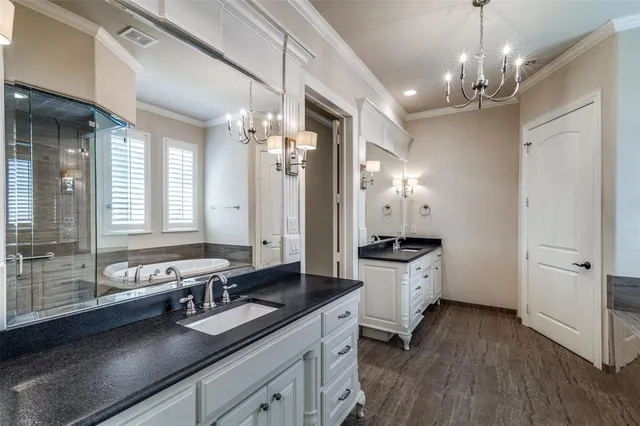 a spacious bathroom with a granite countertop sink a large mirror and a shower