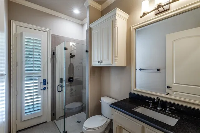 a bathroom with a granite countertop sink toilet a mirror and shower