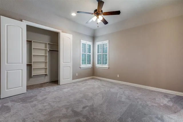 an empty room with windows and closet