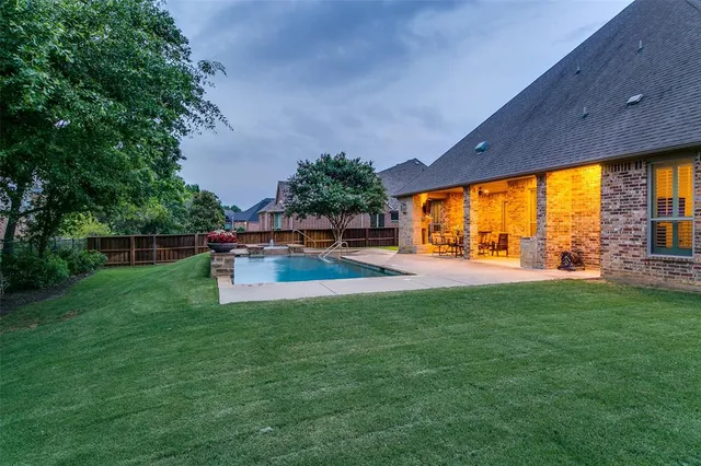 a view of a garden and swimming pool