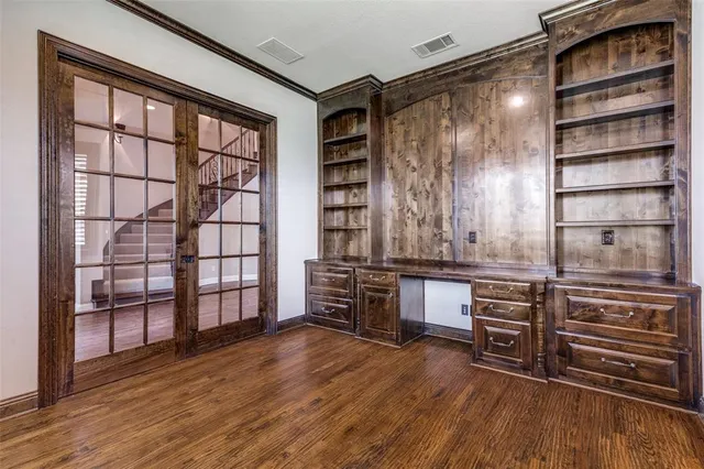a kitchen with stainless steel appliances wooden floors and wooden cabinets