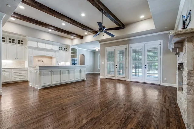 a view of a room with wooden floors and windows