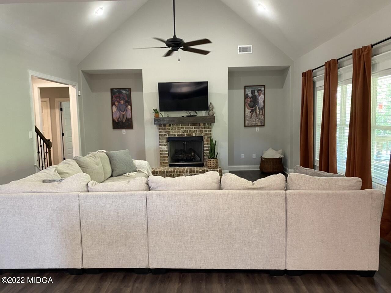 101 Carters Way Forsyth, GA 31029 - Photo 11 of 28 a living room with furniture a fireplace and a flat screen tv