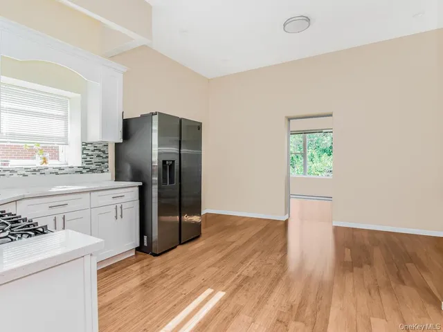 a kitchen with a refrigerator sink and cabinets
