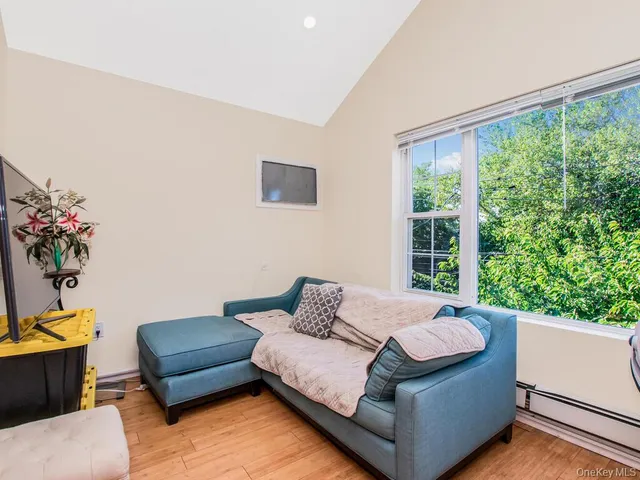 a bedroom with a bed and painting on the wall