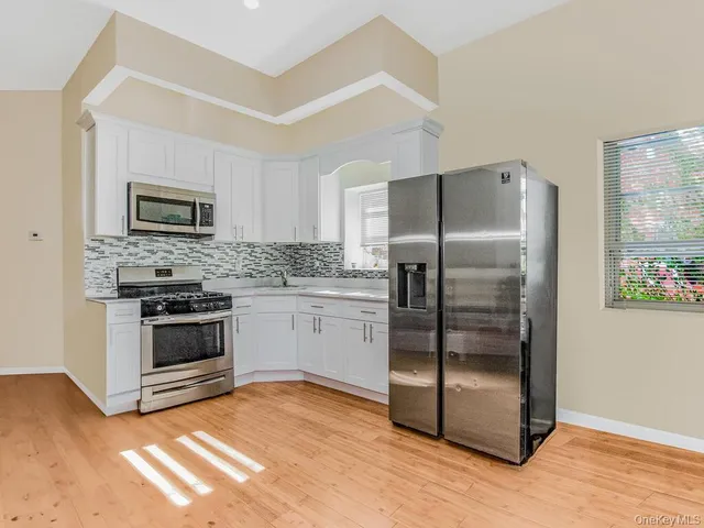 a kitchen with a refrigerator stove and microwave