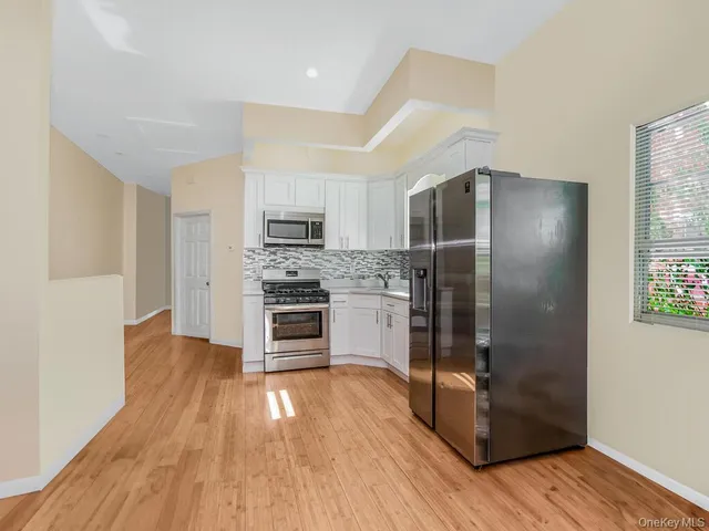 a kitchen with a refrigerator and a stove top oven