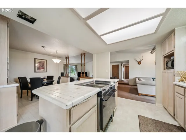 a kitchen with a dining table chairs and white cabinets