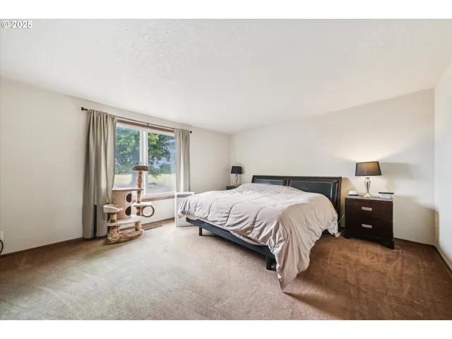 a spacious bedroom with a bed and a mirror