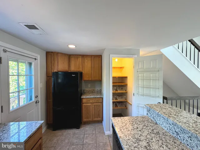 a kitchen with a refrigerator and a sink