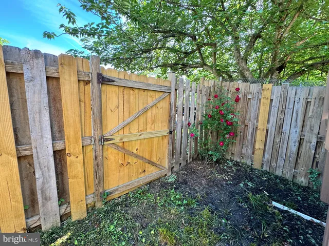 a view of entryway with wooden stairs and a potted plant