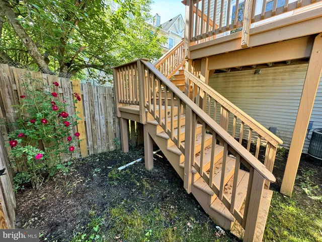 a view of a house with backyard and deck