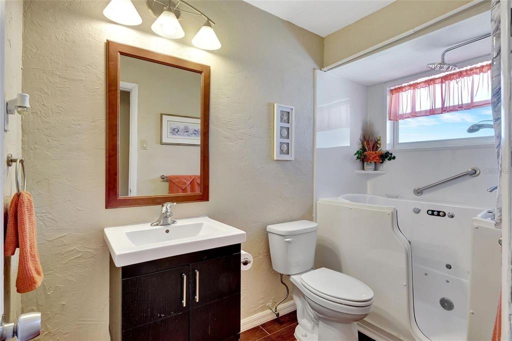 250 Bangsberg Road Southeast Port Charlotte, FL 33952 - Photo 21 of 59 a bathroom with a sink a toilet and shower