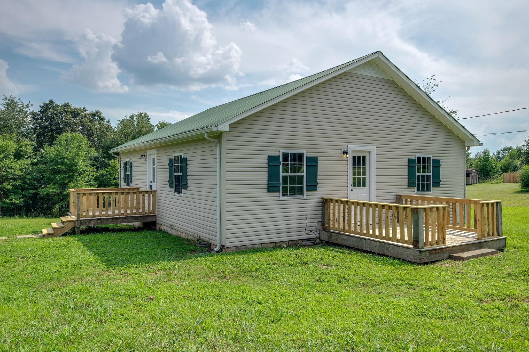 1671 Eno Road Dickson, TN 37055 - Photo 1 of 24 a view of a house with a yard and deck
