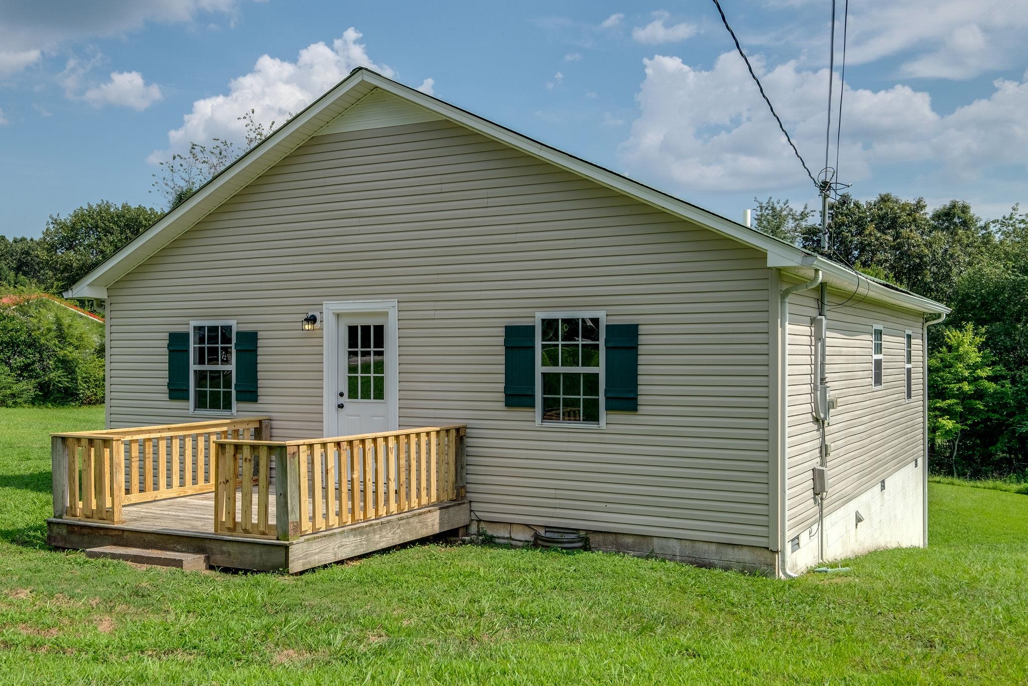 1671 Eno Road Dickson, TN 37055 - Photo 12 of 24 a view of a house with a yard and deck