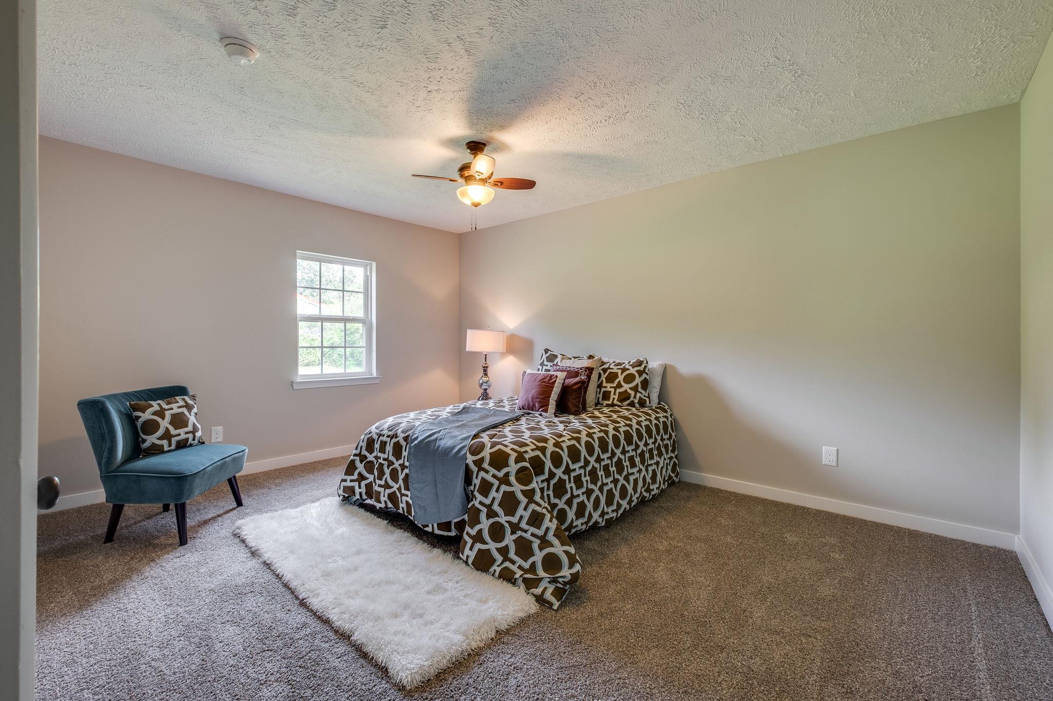 1671 Eno Road Dickson, TN 37055 - Photo 13 of 24 a living room with a bed furniture chandelier and a window