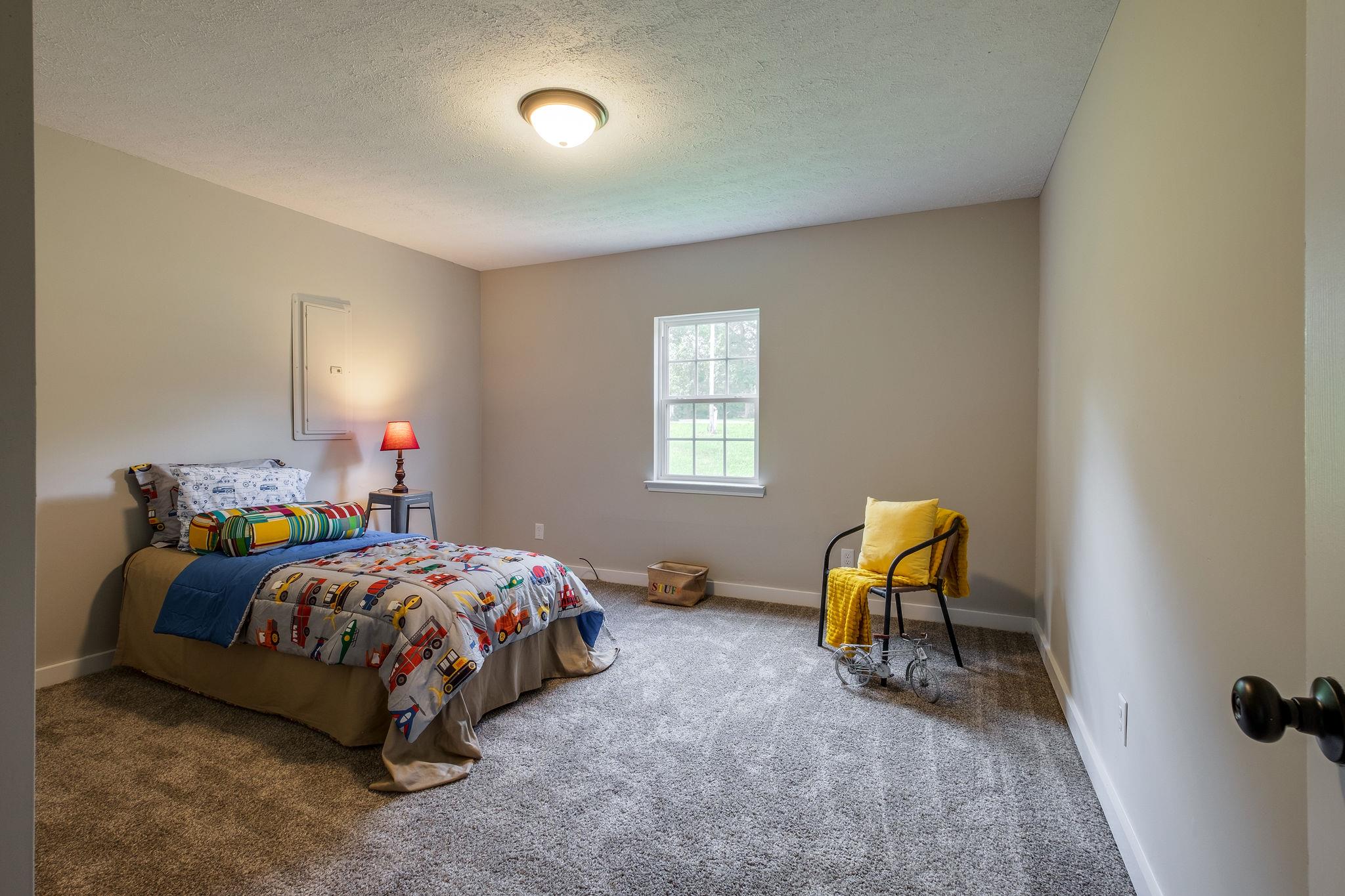 1671 Eno Road Dickson, TN 37055 - Photo 19 of 24 a bedroom with a bed a desk and chair