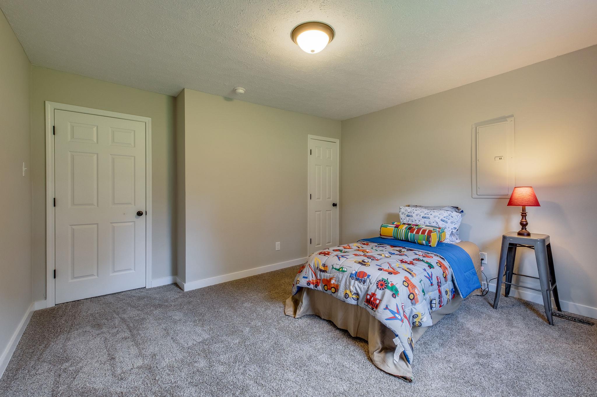1671 Eno Road Dickson, TN 37055 - Photo 20 of 24 a bedroom with a bed and a lamp