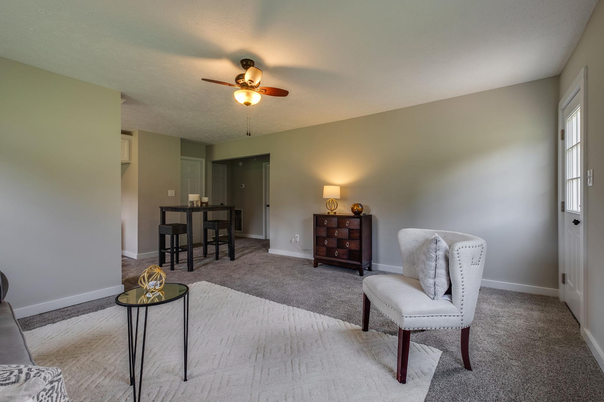 1671 Eno Road Dickson, TN 37055 - Photo 4 of 24 a living room with furniture and a chandelier