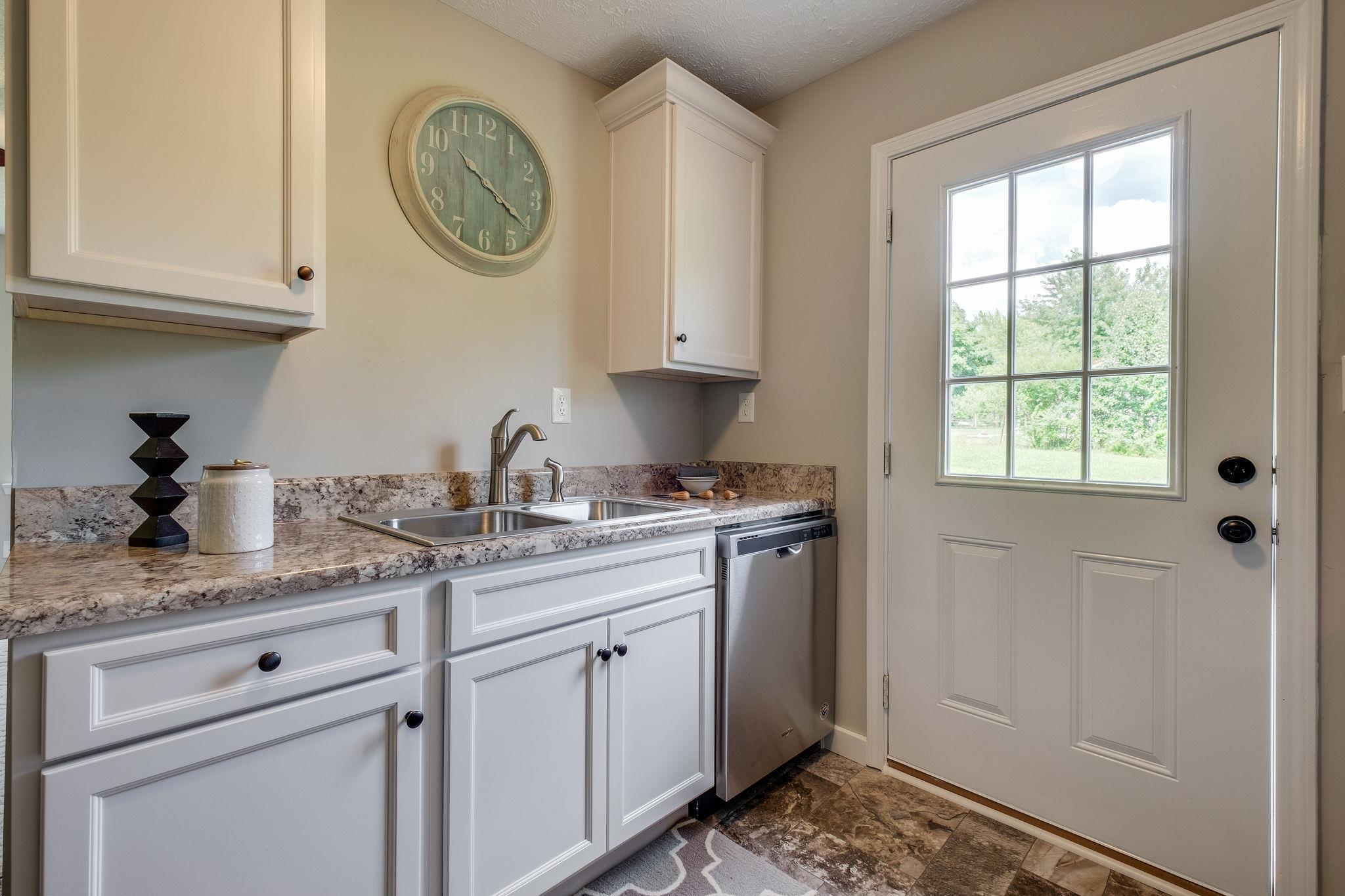 1671 Eno Road Dickson, TN 37055 - Photo 8 of 24 a kitchen with stainless steel appliances granite countertop a sink and a window