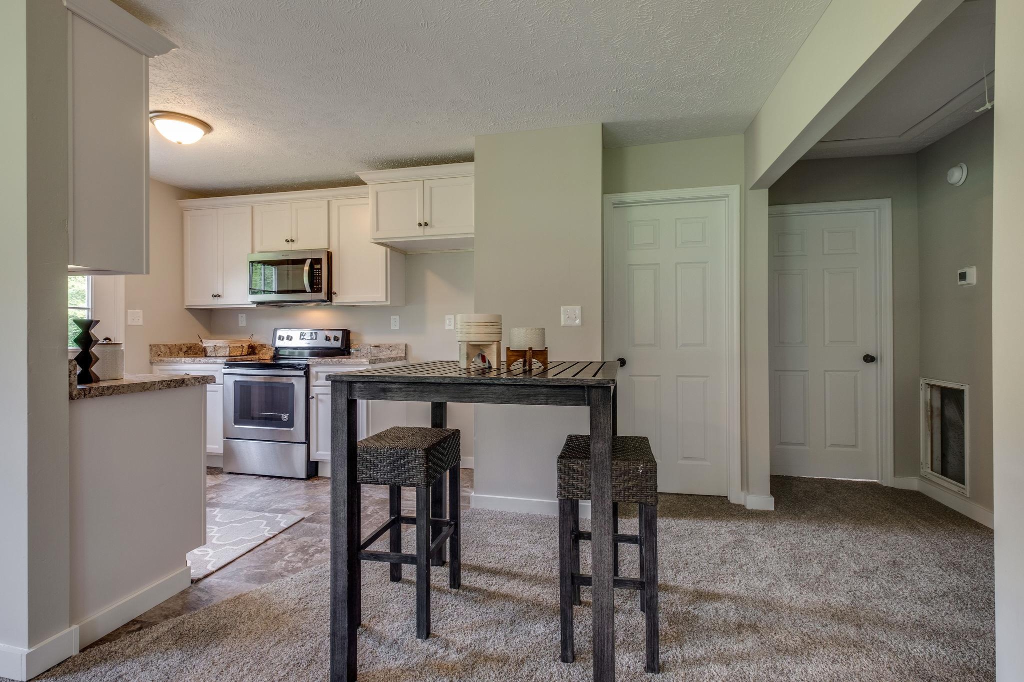 1671 Eno Road Dickson, TN 37055 - Photo 9 of 24 a kitchen with stainless steel appliances granite countertop a stove a sink refrigerator and a microwave