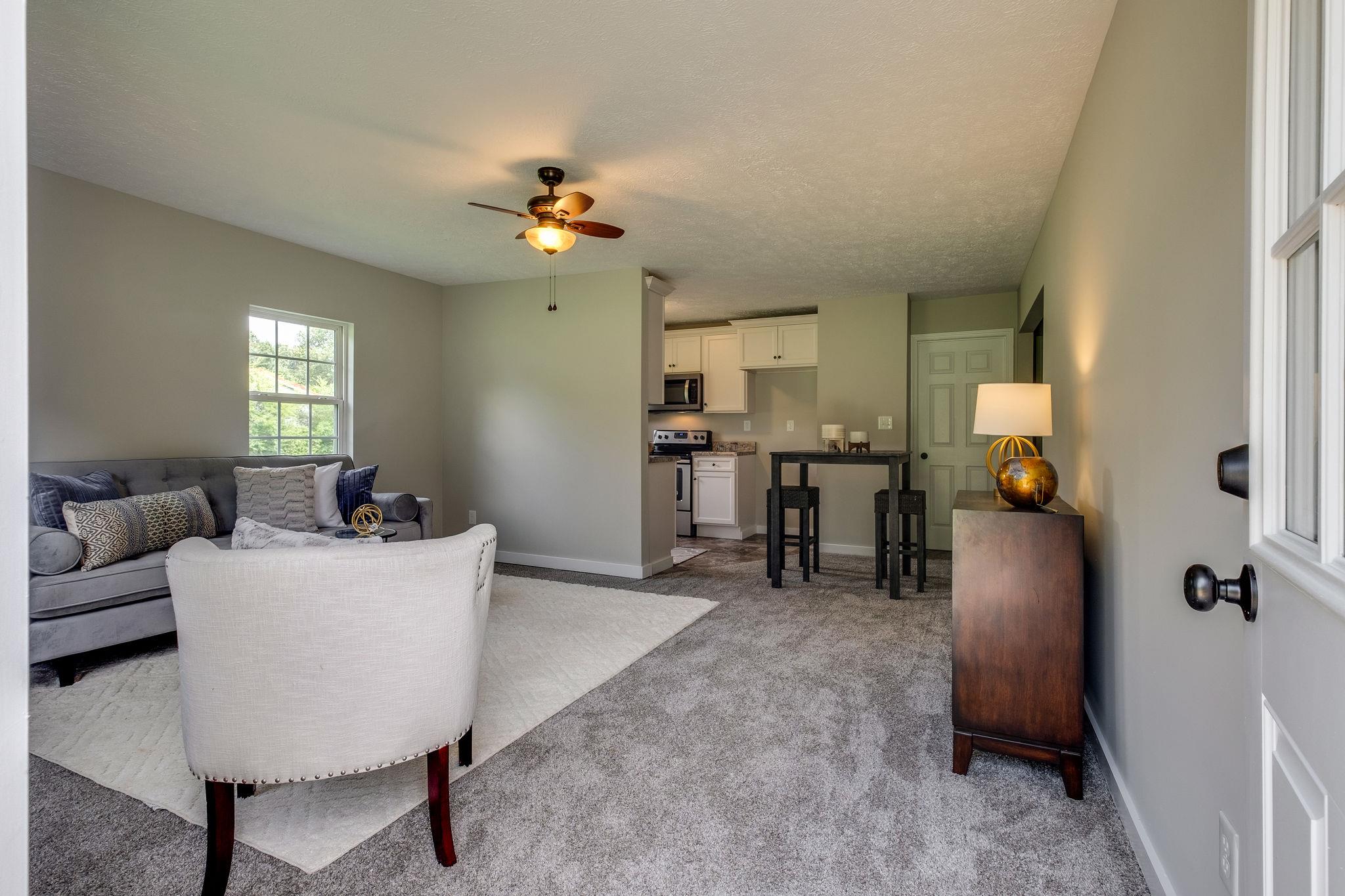 1671 Eno Road Dickson, TN 37055 - Photo 10 of 24 a living room with furniture and a chandelier