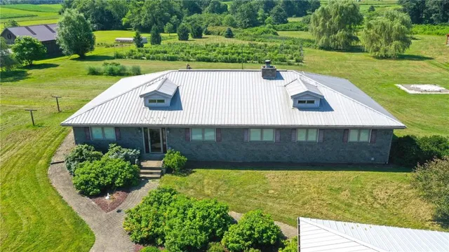 a view of a house with yard and a garden