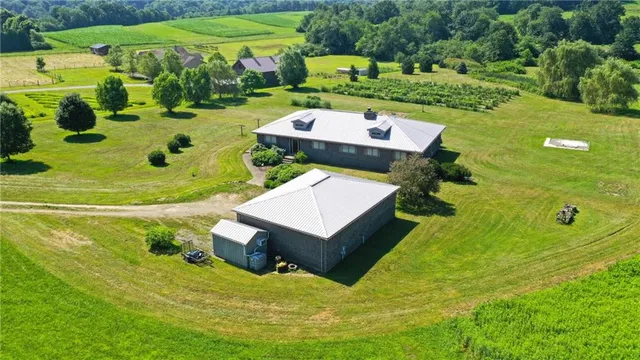 a aerial view of a house with big yard