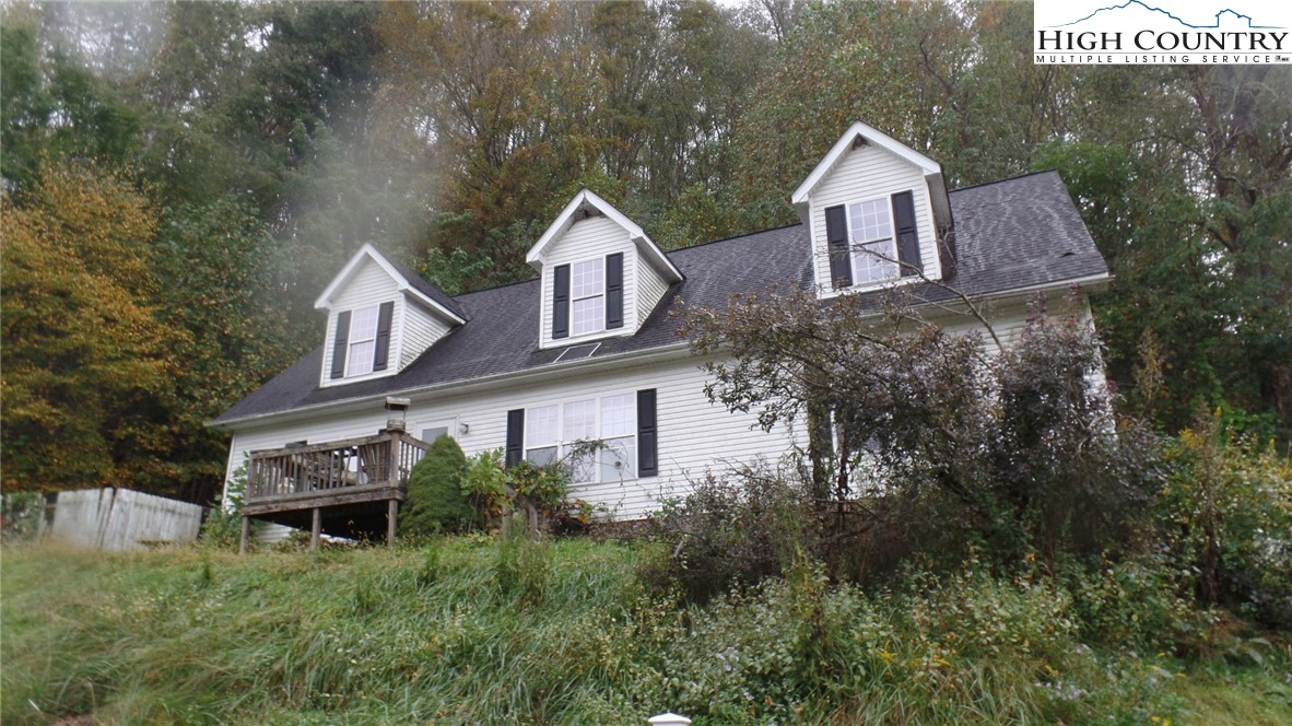 a view of a house with a yard and tree s