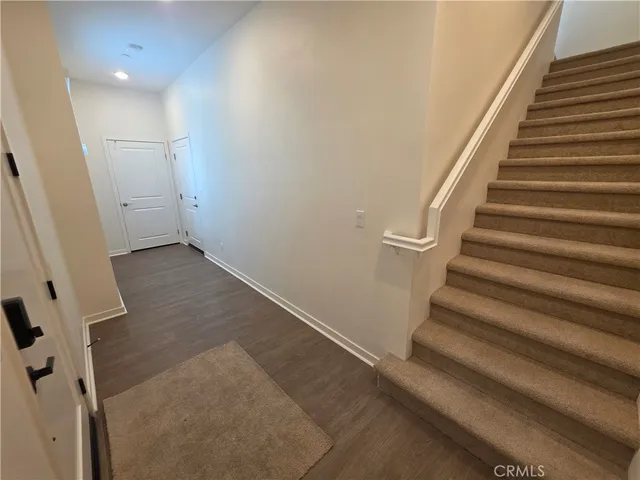 wooden floor in an empty room with stairs