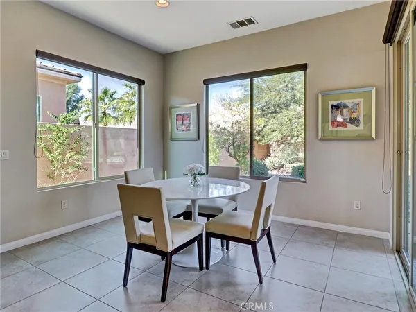 a dining room with furniture and window
