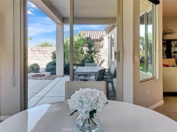 a living room with furniture and large windows