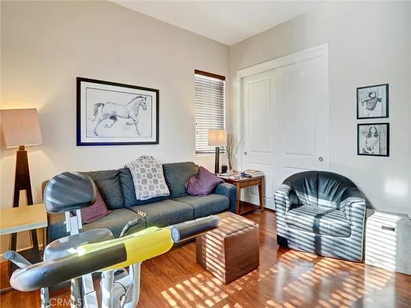 a bedroom with furniture and balcony