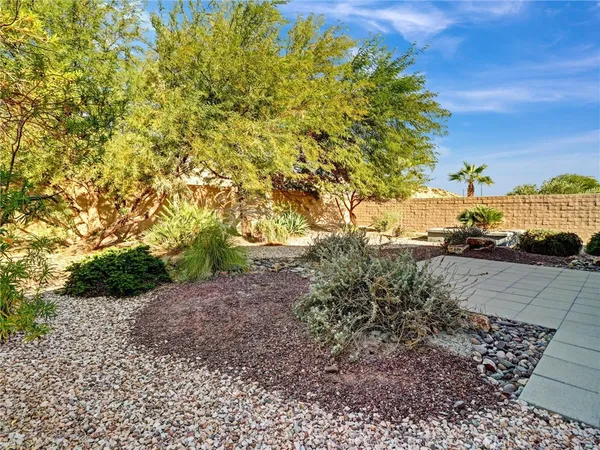 a view of a yard with wooden fence