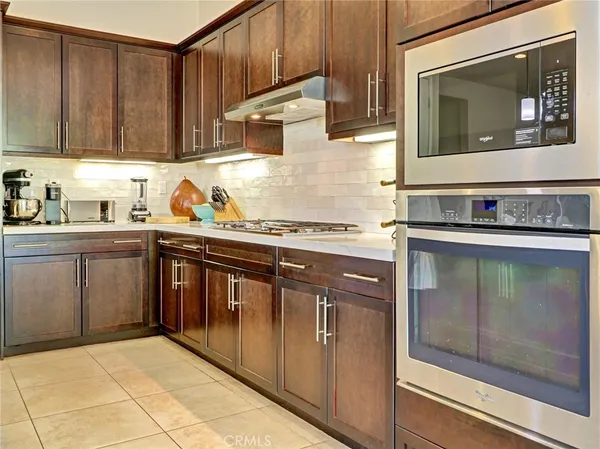 a kitchen with stainless steel appliances granite countertop a stove and a microwave