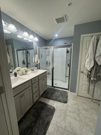 a bathroom with a shower sink and mirror
