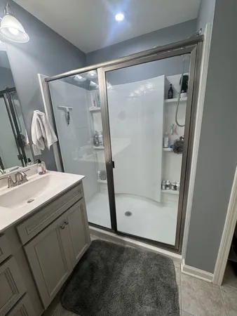 a en suite bathroom with a double vanity sink and a mirror