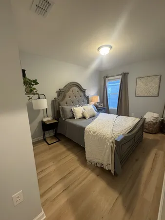 a bedroom with a bed and a dresser