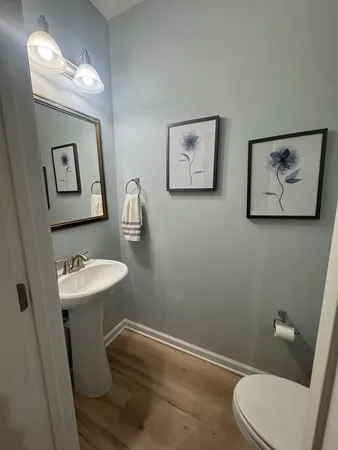 a white toilet sitting next to a white walls