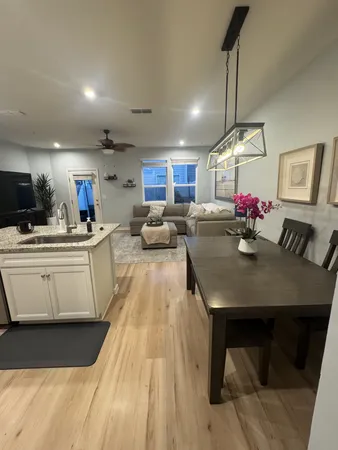 a bedroom with a large bed and a chandelier