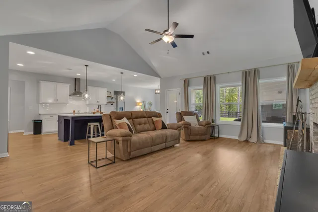 a living room with furniture a flat screen tv and a fireplace