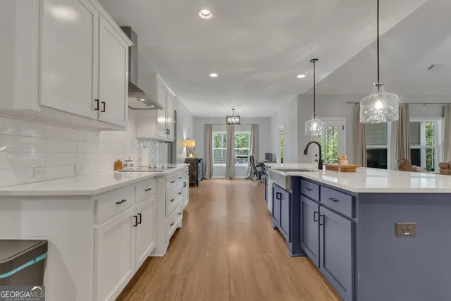a bedroom with a bed and a flat tv screen on dresser
