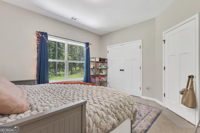 a bed room with a bed and a television