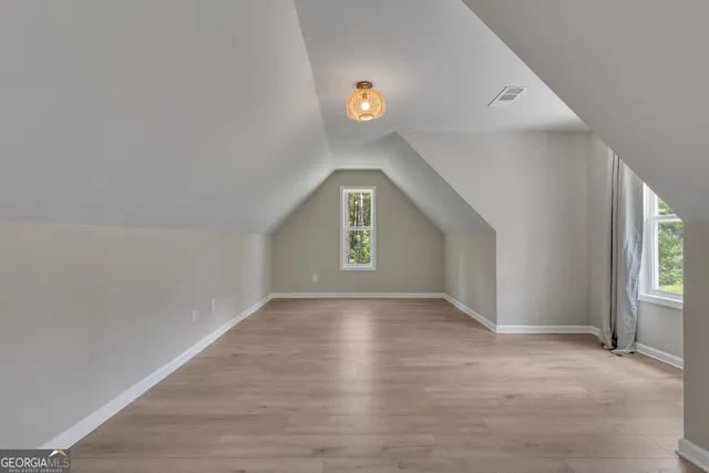 an aerial view of residential house with outdoor space and trees all around