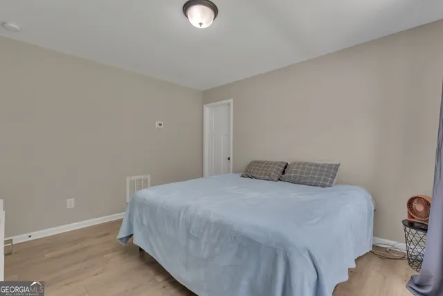 a view of a house with a big yard potted plants and large tree