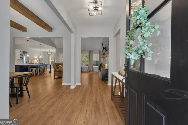 a view of a dining room with furniture and wooden floor
