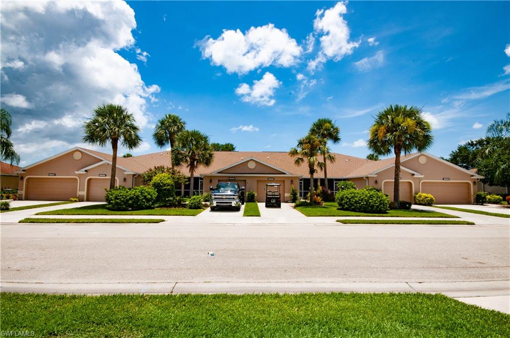 21620 Portrush Run Estero, FL 33928 - Photo 1 of 34 a front view of a house with a yard and a garden