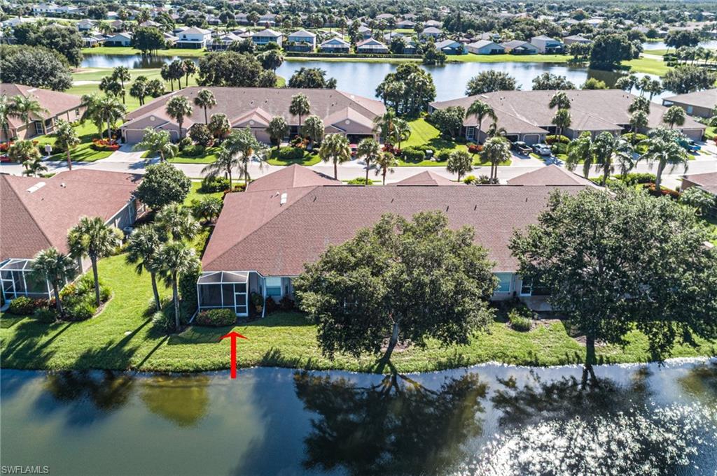 21620 Portrush Run Estero, FL 33928 - Photo 30 of 34 a view of a lake with a city