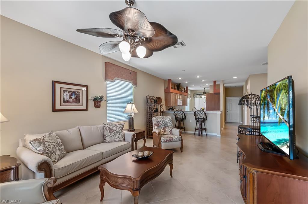 21620 Portrush Run Estero, FL 33928 - Photo 8 of 34 a living room with furniture flat screen tv and couches