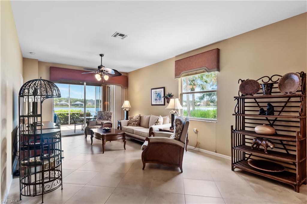 21620 Portrush Run Estero, FL 33928 - Photo 9 of 34 a living room with furniture a chandelier and a large window